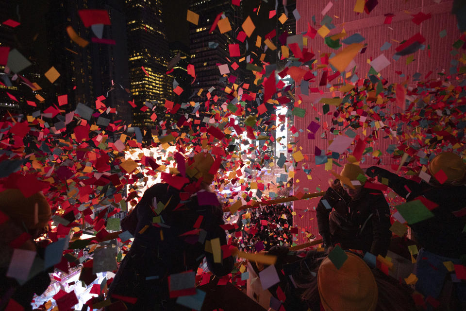 Times Square Alliance volunteers throw confetti as the clock strikes midnight as seen from the New York Marriott Marquis during the New Year's Eve celebration in Times Square, Monday, Jan. 1, 2024, in New York. (AP Photo/Yuki Iwamura)