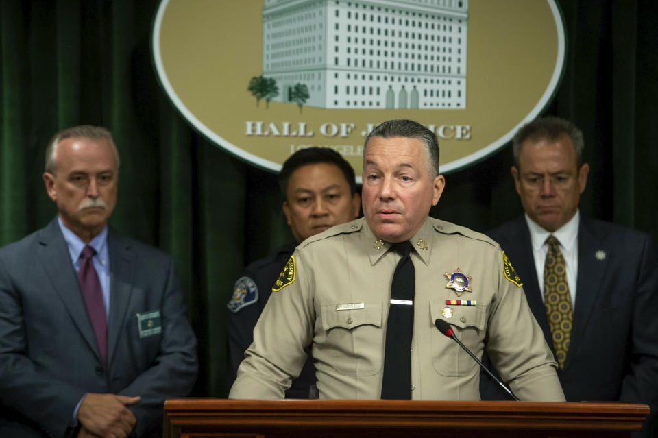 Los Angeles County Sheriff Alex Villanueva, with Sheriff's Homicide Capt. Kent Wegener, from left, Alhambra Police Chief Timothy Vu and LAPD Police Chief Michel Moore, announces during a news conference in Los Angeles on Tuesday, June 11, 2019. Rhett Nelson, 30, of St. George, Utah, was arrested Tuesday on suspicion of shooting an off-duty Los Angeles County sheriff’s deputy at a fast-food restaurant Monday, and authorities say they are investigating whether he may have killed another man an hour earlier in attacks that both appear to be random. (Sarah Reingewirtz/The Orange County Register via AP)