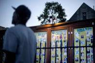 A pedestrian walks by a long standing memorial to victims of gun violence outside St. Sabina Catholic Church in the Auburn Gresham neighborhood in Chicago, Thursday, Aug. 27, 2020. Last year, 1,149 guns were recovered from the 6th police district, which includes Auburn Gresham, about 10 percent of the haul for the entire city. As of the end of September, the district had recorded 59 homicides this year, nearly 60 percent higher than the same period last year. (AP Photo/David Goldman)