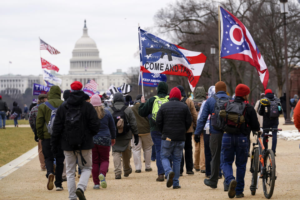 FILE - In this Wednesday, Jan. 6, 2021, file photo, supporters of President Donald Trump march towards the Capitol holding flags during rally in Washington. War-like imagery has begun to take hold in mainstream Republican political circles in the wake of the deadly attack on the U.S. Capitol, with some elected officials and party leaders rejecting calls to tone down their rhetoric contemplating a second civil war. (AP Photo/Carolyn Kaster, File)