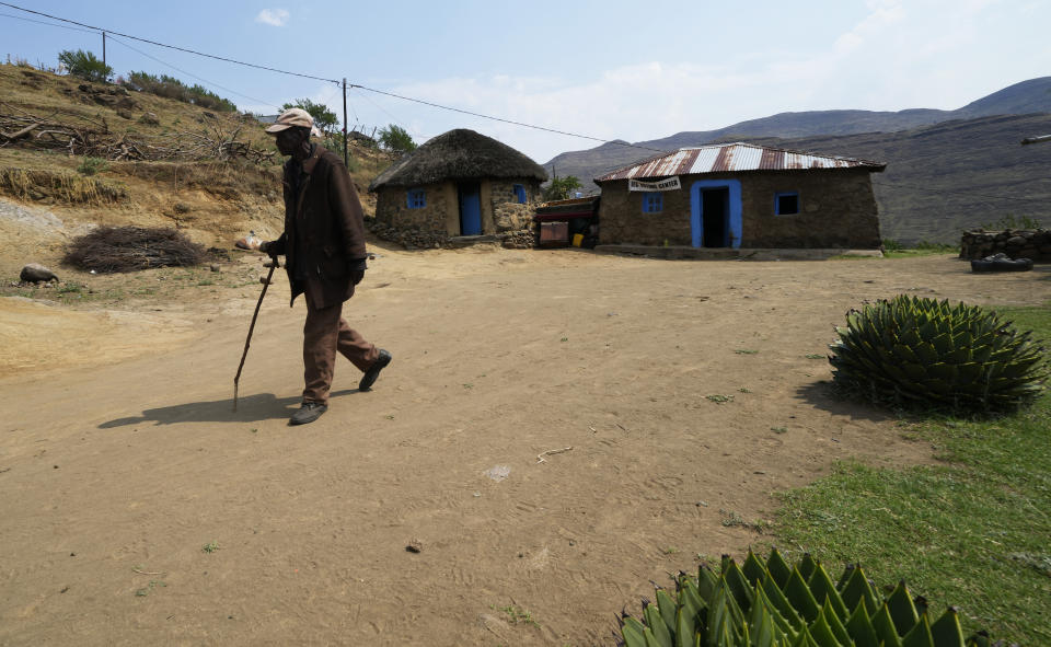 An elderly man leaves a polling station after casting his vote in Thaba-Tseka District, 82km east of Maseru, Lesotho, Friday, Oct. 7, 2022. Voters across Lesotho are heading to the polls Friday to elect a leader to find solutions to high unemployment and crime. (AP Photo/Themba Hadebe)