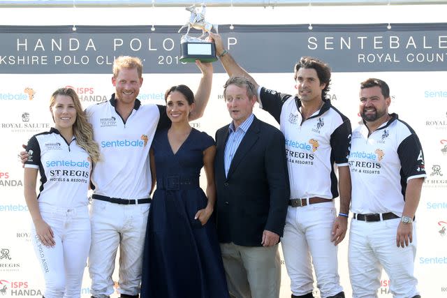 <p>Chris Jackson/Getty </p> Ashley van Metre Busch, Prince Harry Duke of Sussex, Meghan Duchess of Sussex, Enda Kenny, Nacho Figuares and Miguel Mendoza pose with the Sentebale Polo 2018 trophy.