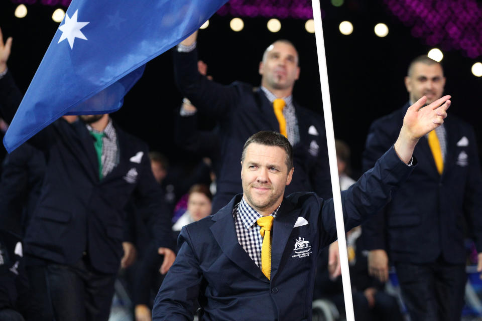 LONDON, ENGLAND - AUGUST 29: Wheelchair rugby player Greg Smith of Australia carries the flag during the Opening Ceremony of the London 2012 Paralympics at the Olympic Stadium on August 29, 2012 in London, England. (Photo by Dan Kitwood/Getty Images)