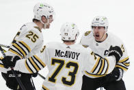 Boston Bruins' Brad Marchand (63) celebrates his goal against the Toronto Maple Leafs with Brandon Carlo (25) and Charlie McAvoy (73) during third period of action in Game 3 of an NHL hockey Stanley Cup first-round playoff series in Toronto on Wednesday, April 24, 2024. (Frank Gunn/The Canadian Press via AP)