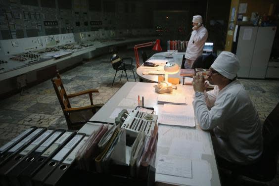 Workers sit in the control room of reactor number two inside the former Chernobyl nuclear power plant in 2015 (Sean Gallup/Getty Images)