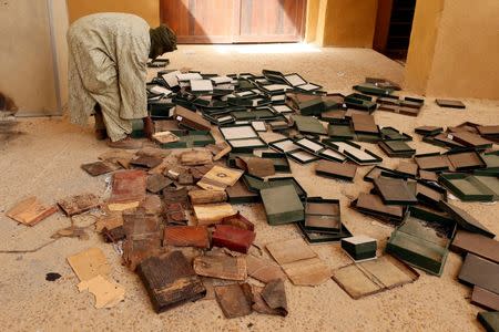 A museum guard works around boxes which held ancient manuscripts which were partially damaged at the Ahmed Baba Institute, or Ahmed Baba Centre for Documentation and Research, in Timbuktu January 31, 2013. REUTERS/Benoit Tessier/Files