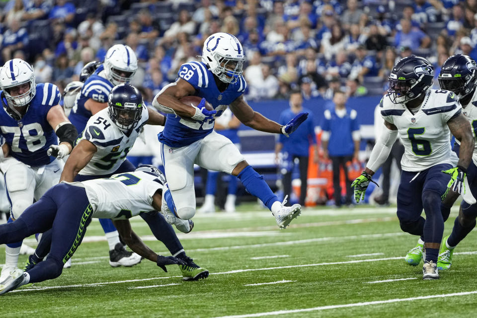 Indianapolis Colts running back Jonathan Taylor (28) leaps over Seattle Seahawks defensive back Marquise Blair (27) during the second half of an NFL football game in Indianapolis, Sunday, Sept. 12, 2021. (AP Photo/AJ Mast)