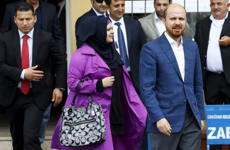 Bilal Erdogan (R), son of Turkish President Tayyip Erdogan, and his wife Reyvan Uzuner Erdogan leave a polling station after casting their votes during the parliamentary election in Istanbul, Turkey, June 7, 2015. REUTERS/Murad Sezer/Files