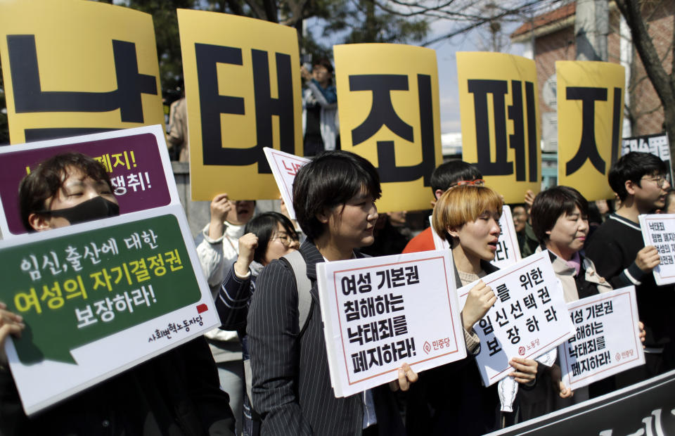 Protesters shout slogans during a rally demanding the abolition of the country's ban on abortions outside of the Constitutional Court in Seoul, South Korea, Thursday, April 11, 2019. South Korea's Constitutional Court has ruled that the country's decades-long ban on abortions is incompatible with the constitution, setting up a likely easing of restrictions. (AP Photo/Lee Jin-man)