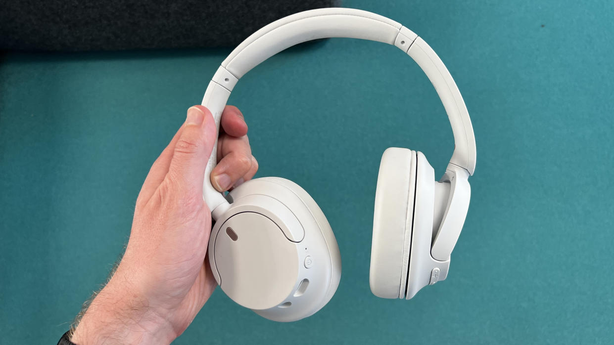  Sony WH-CH520N headphones held in a hand 