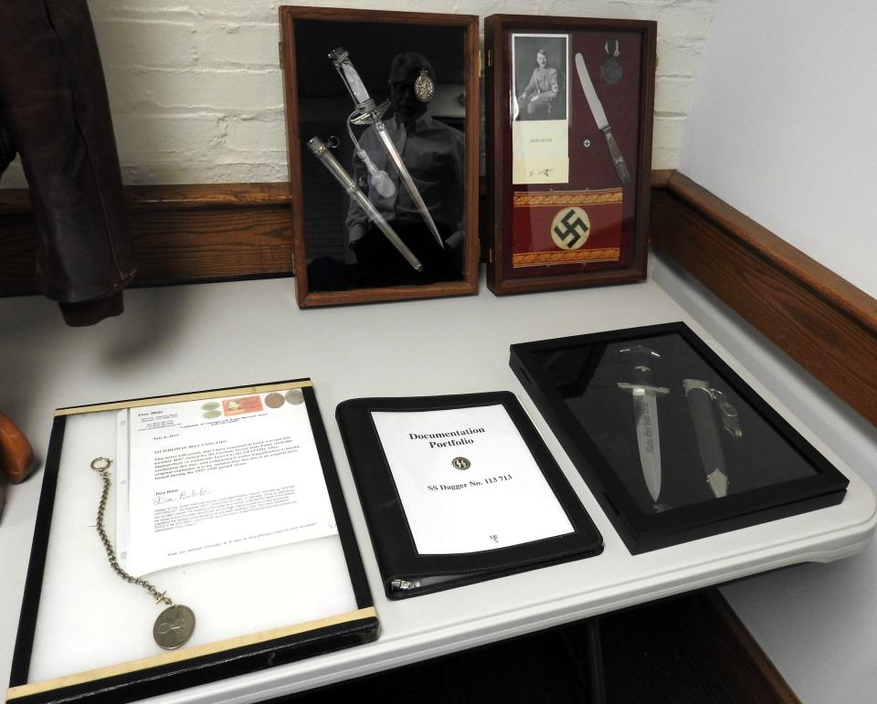 A collection of knives, a Gestapo badge and other items from the collection of Bill Given.