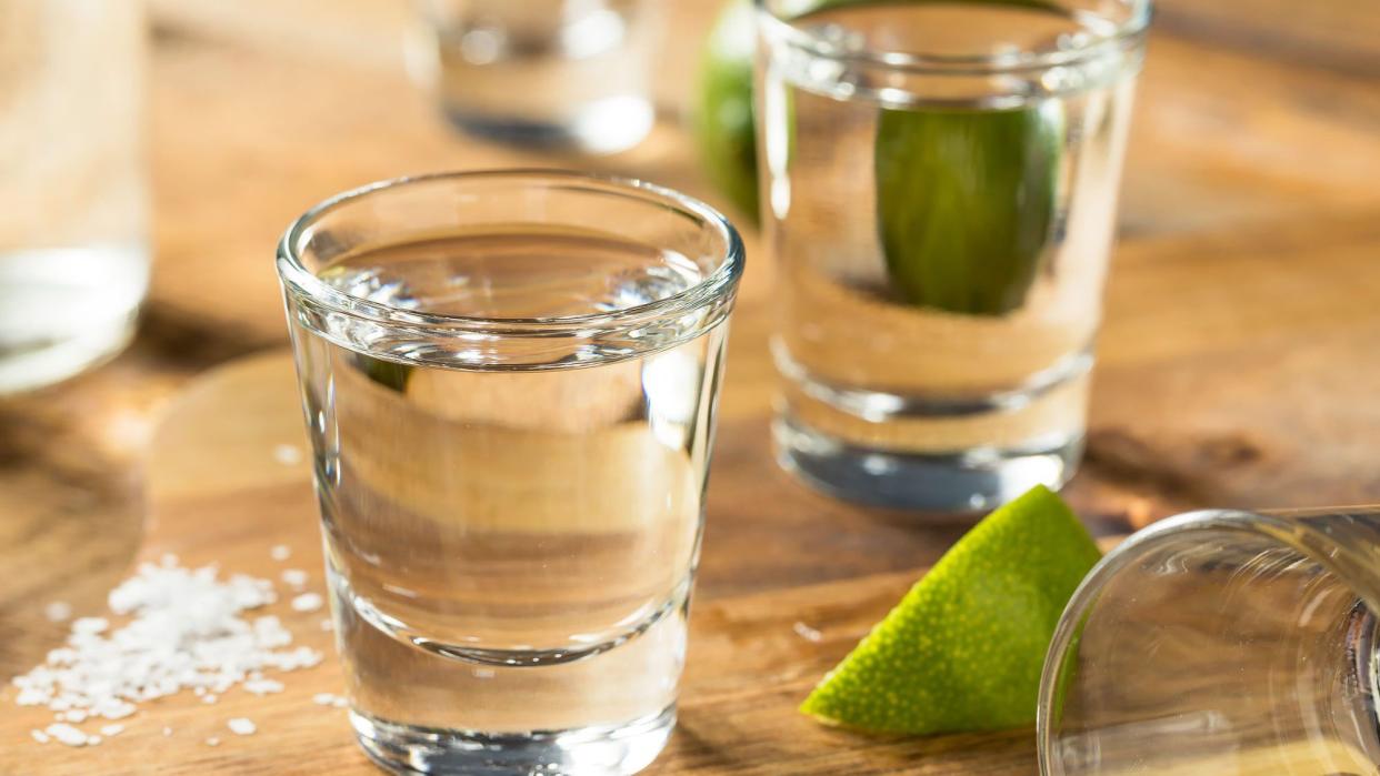 Tequila in shot glasses with limes and salt