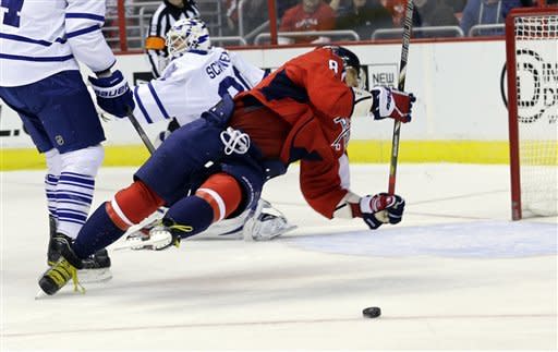Washington Capitals left wing Alex Ovechkin (8) from Russia, falls to the ice as the puck goes past in the first period of an NHL hockey game against the Toronto Maple Leafs on Tuesday, Feb. 5, 2013, in Washington. (AP Photo/Alex Brandon)