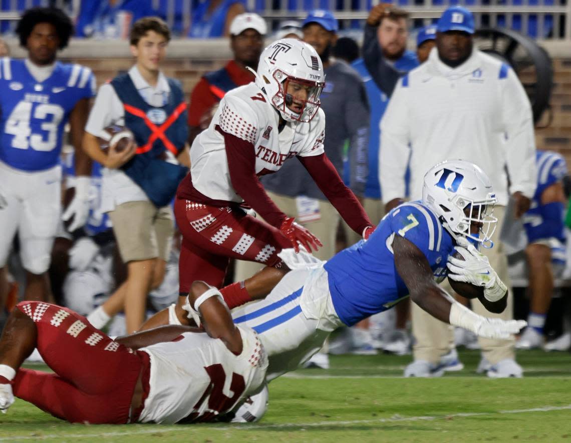 Duke running back Jordan Waters (7) is brought down by Temples Alex Odom and Jalen McMurray during the second half of the Blue Devils season opener at Wallace Wade Stadium on Friday, Sept. 2, 2022, in Durham, N.C.