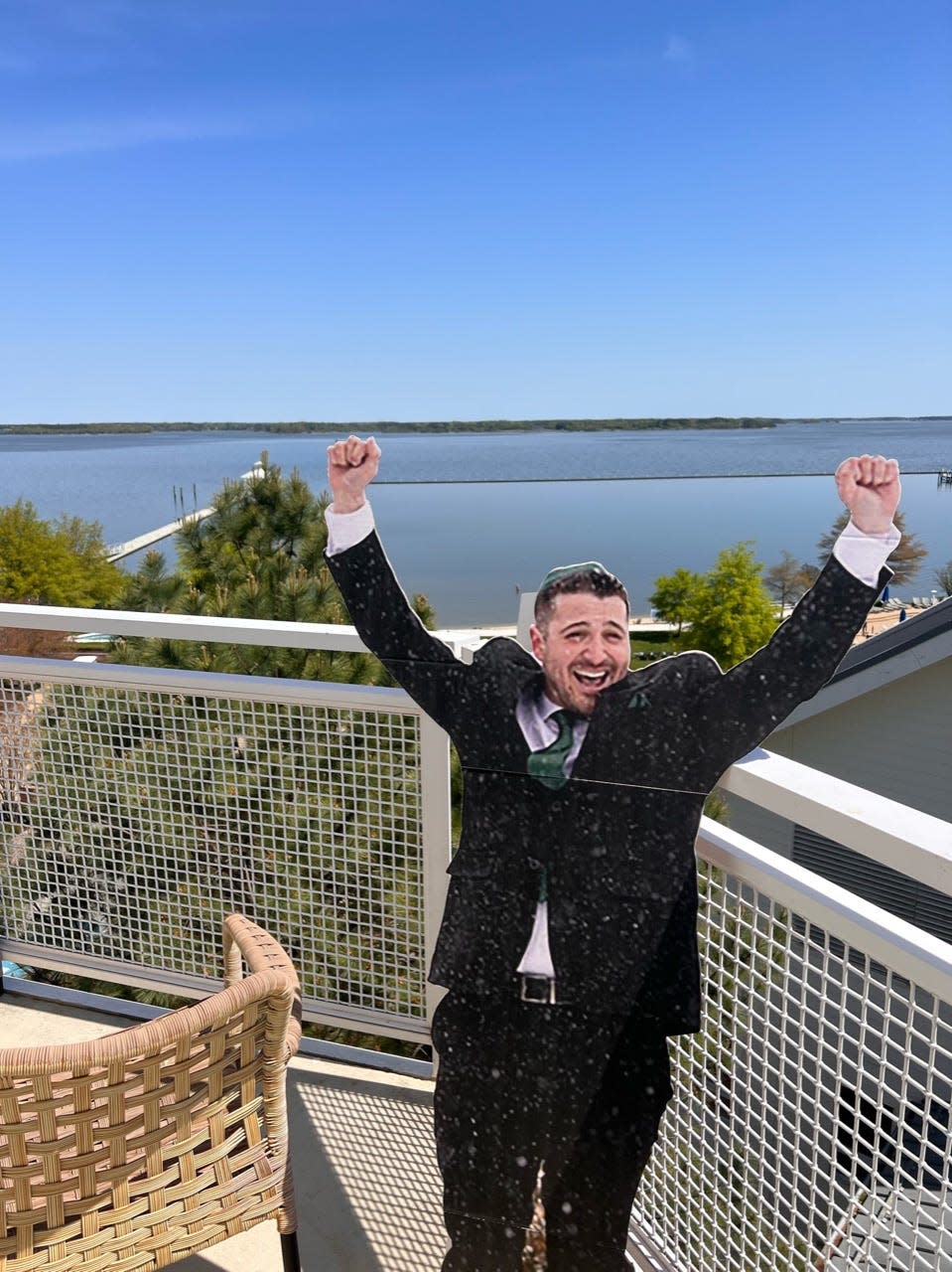 Cardboard cutout of Sam placed on the couple's balcony