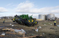 National Weather Service meteorologist Andrew Quigley, left, and Tim Halbach, warning coordination meteorologist, check out damage to farming equipment and out buildings from a tornado in Evansville, Wis., Friday, Feb. 9, 2024. The first tornado ever recorded in Wisconsin in the usually frigid month of February came on a day that broke records for warmth, the type of severe weather normally seen in the late spring and summer. (Amber Arnold/Wisconsin State Journal via AP)