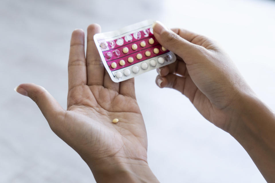 Woman taking a birth control pill
