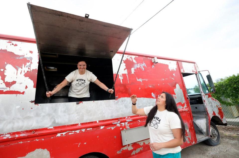 Ellie Yagi and Erika Yagi, co-owners of Yagi's Dump Truck, close the window of their work-in-progress food truck, where they will sell dumplings, in Murray on Wednesday.
