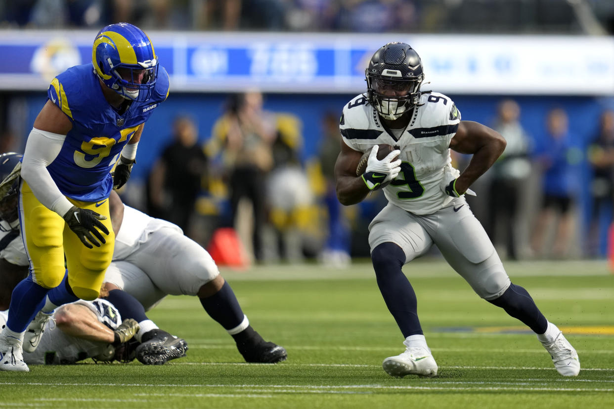 Kenneth Walker III clutched his left side after sustaining a non-contact oblique injury. (AP Photo/Ashley Landis)