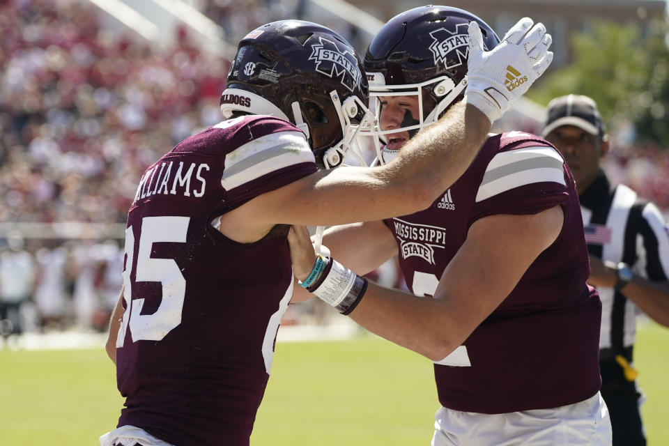 Mississippi State wide receiver Austin Williams (85) celebrates his 10-yard pass reception with quarterback Will Rogers (2) during the first half of an NCAA college football game against Arkansas in Starkville, Miss., Saturday, Oct. 8, 2022. (AP Photo/Rogelio V. Solis)