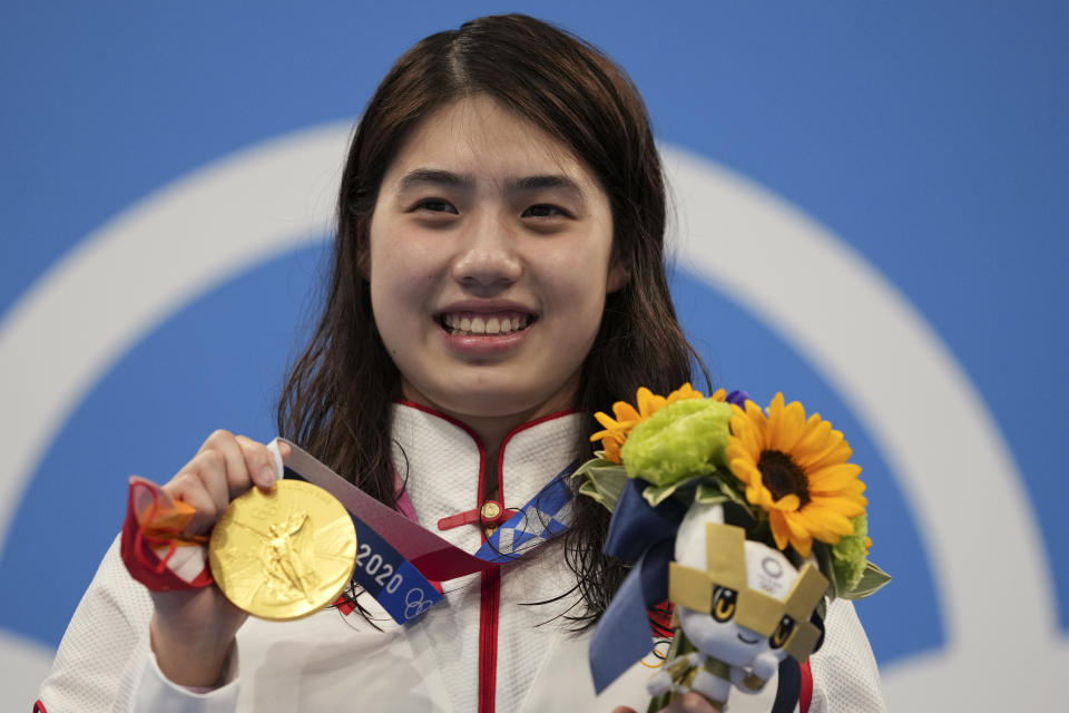 Zhang Yufei of China poses with her gold medal after winning the women's 200-meter butterfly final at the 2020 Summer Olympics, Thursday, July 29, 2021, in Tokyo, Japan. (AP Photo/Matthias Schrader)