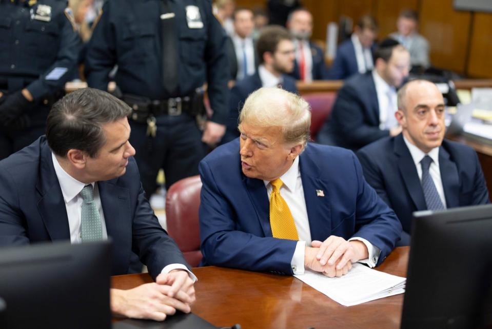 Donald Trump speaks with his attorneys during his hush money trial in Manhattan on 14 May (AP)