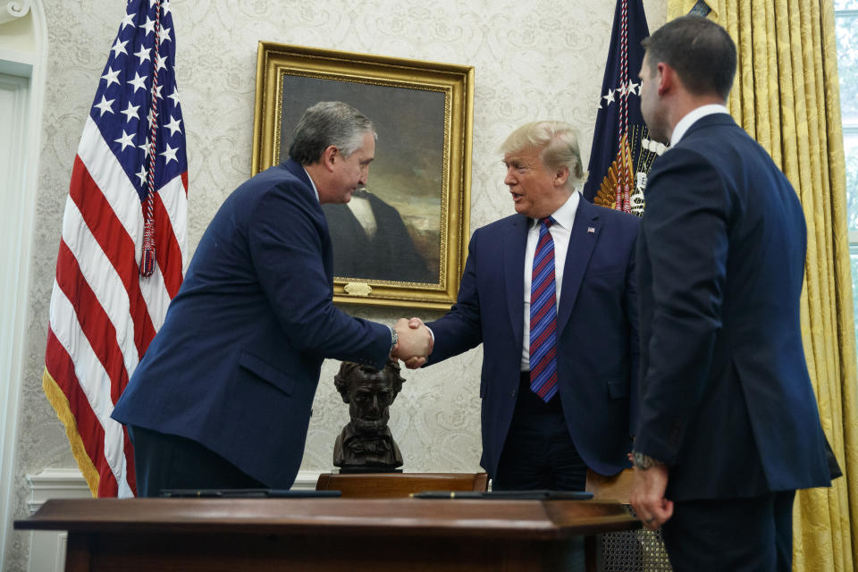 President Donald Trump, joined by acting Department of Homeland Security Secretary Kevin McAleenan, right, shakes hands with Guatemalan Interior Minister Enrique Degenhart in the Oval Office of the White House in Washington, Friday, July 26, 2019. Trump announced that Guatemala is signing an agreement to restrict asylum applications to the U.S. from Central America. (AP Photo/Carolyn Kaster)