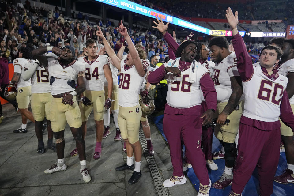 Florida State players celebrate in front of the team's fans after defeating Florida in an NCAA college football game Saturday, Nov. 25, 2023, in Gainesville, Fla. (AP Photo/John Raoux)