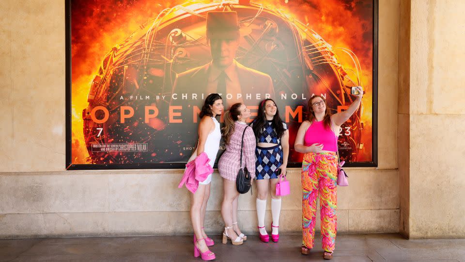 "Barbenheimer" viewers dressed like Barbie to see "Oppenheimer" in this photo from the opening weekend of both films last July. It was common to see moviegoers rocking pink, even to see the intense biopic, to the theater for weeks after the films' release. - Chris Pizzello/AP