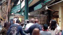 <p>Onlookers view a New Jersey Transit train that derailed and crashed through the station in Hoboken, N.J., on Sept. 29, 2016. (Courtesy of Chris Lantero via REUTERS) </p>