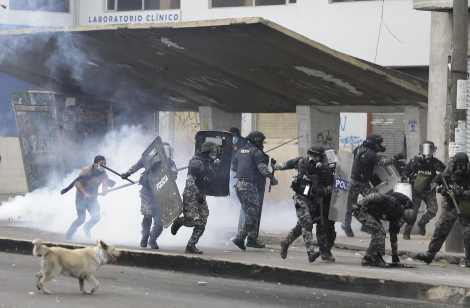 Anti-government demonstrators clash with police in Quito, Ecuador, Friday, Oct. 11, 2019. Protests started last week after Ecuador's President Lenin Moreno ended fuel subsidies. The disturbances have spread from transport workers to students and then to indigenous demonstrators. (AP Photo/Fernando Vergara)