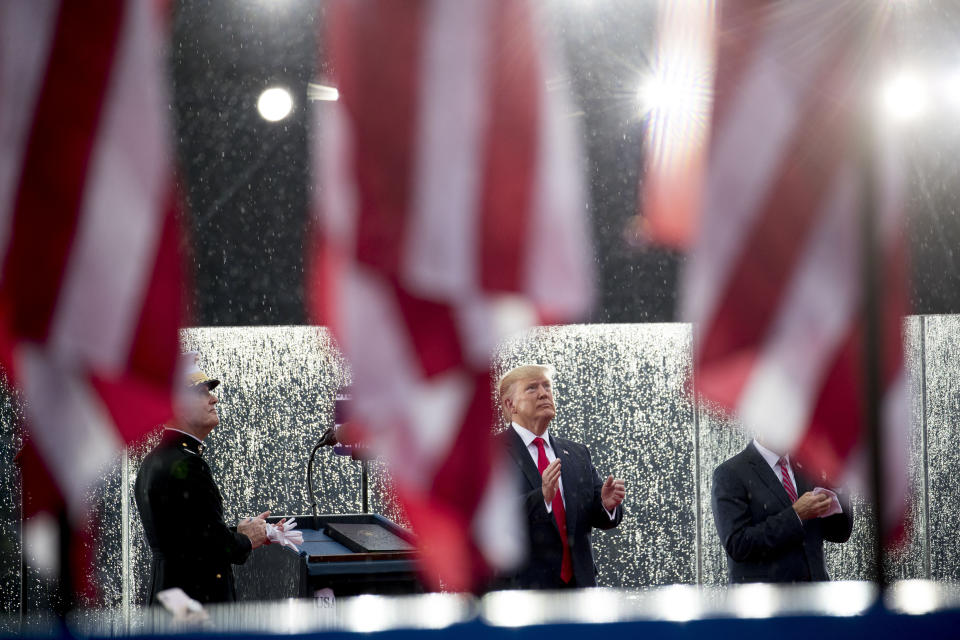 President Donald Trump, accompanied by Joint Chiefs Chairman Gen. Joseph Dunford, left, and Acting Defense Secretary Mark Esper, right, watch as aircraft flyover during an Independence Day celebration in front of the Lincoln Memorial, Thursday, July 4, 2019, in Washington. (AP Photo/Andrew Harnik)