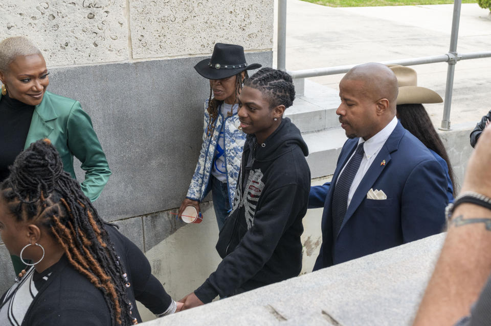 Darryl George, center, enters the courthouse before a hearing regarding George's punishment for violating school dress code policy because of his hair style, Thursday Feb. 22, 2024 at the Chambers County Courthouse in Anahuac, Texas. A judge has ruled that George's monthslong punishment by his Texas school district for refusing to change his hairstyle does not violate a new state law prohibiting race-based hair discrimination. (Kirk Sides/Houston Chronicle via AP)