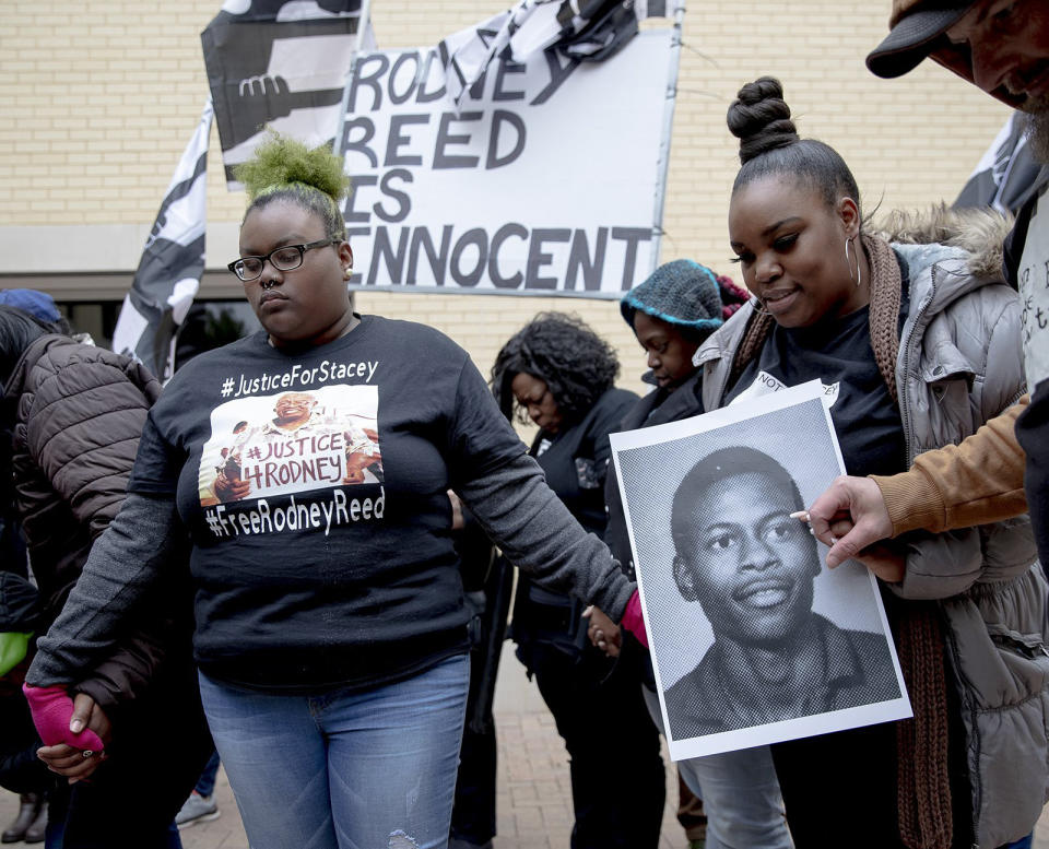 People hold hands while praying during a protest against the execution of Rodney Reed on Wednesday, Nov. 13, 2019, in Bastrop, Texas. Protesters rallied in support of Reed’s campaign to stop his scheduled Nov. 20 execution for the 1996 killing of a 19-year-old Stacy Stites. New evidence in the case has led a growing number of Texas legislators, religious leaders and celebrities to press Gov. Greg Abbott to intervene. (Nick Wagner/Austin American-Statesman via AP)