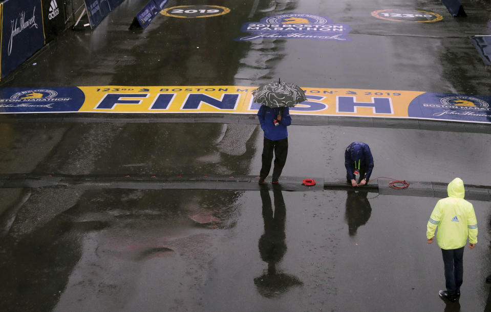 Final preparations are made in the rain at the finish line for the 123rd Boston Marathon on Monday, April 15, 2019, in Boston. (AP Photo/Charles Krupa)