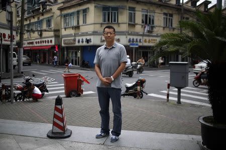 Zhang Bowen, who was born in 1985, poses for a photograph in Shanghai July 25, 2014. REUTERS/Carlos Barria/Files