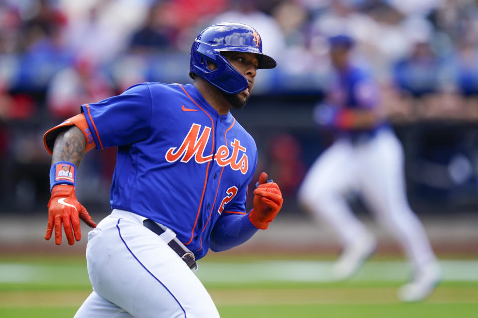 New York Mets' Dominic Smith runs to second base for an RBI double as Jeff McNeil scores during the third inning in the first baseball game of a doubleheader Tuesday, May 17, 2022, in New York. (AP Photo/Frank Franklin II)