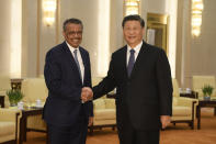 FILE - In this Jan. 28, 2020, file photo, Tedros Adhanom Ghebreyesus, director general of the World Health Organization, left, shakes hands with Chinese President Xi Jinping before a meeting at the Great Hall of the People in Beijing. Throughout January, the World Health Organization publicly praised China for what it called a speedy response to the new coronavirus. It repeatedly thanked the Chinese government for sharing the genetic map of the virus “immediately” and said its work and commitment to transparency were “very impressive, and beyond words.” But behind the scenes, there were significant delays by China and considerable frustration among WHO officials over the lack of outbreak data, The Associated Press has found. (Naohiko Hatta/Pool Photo via AP, File)