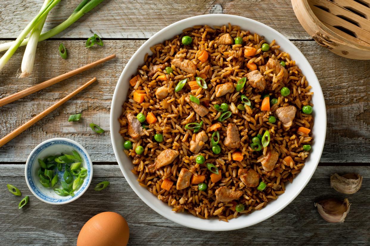 Delicious pork fried rice with egg, carrot, green peas, garlic and green onion.