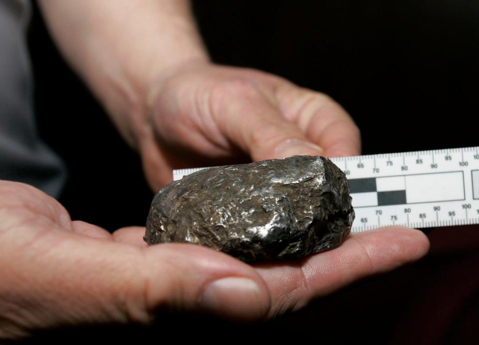 This Jan. 3, 2007 file photo shows an object that came through the roof of a Freehold Township, New Jersey, home. The mysterious metallic object that crashed through the roof of a central New Jersey family's home. First thought to be a meteorite, geologists later said it is likely "orbital debris," perhaps remnants of a satellite, rocket, or another spacecraft component.