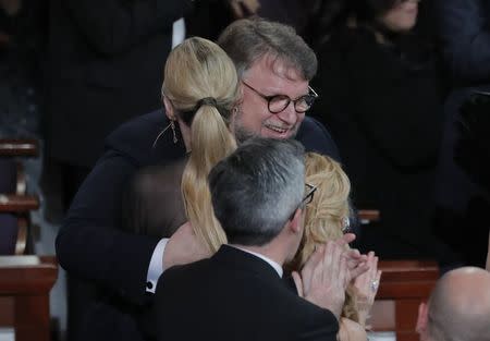 90th Academy Awards - Oscars Show - Hollywood, California, U.S., 04/03/2018 - Guillermo del Toro is hugged by his guest Kim Morgan after winning Best Director for "The Shape of Water." REUTERS/Lucas Jackson