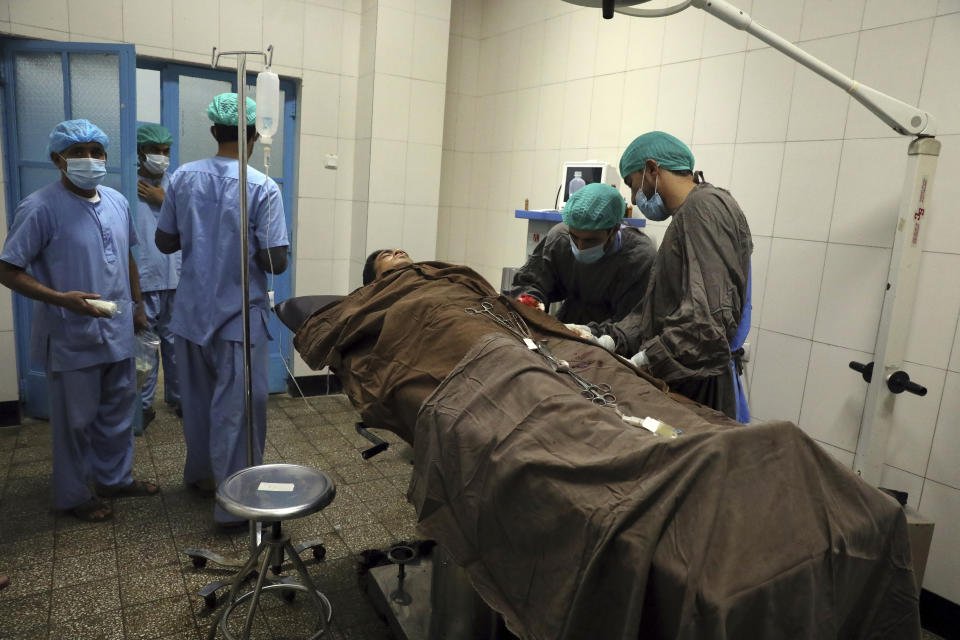 A man is treated at a hospital after a deadly attack at Kabul University, in Kabul, Afghanistan, Monday, Nov. 2, 2020. The brazen attack by gunmen who stormed the Kabul University has left many dead and wounded in the Afghan capital. The assault sparked a hours-long gunbattle. (AP Photo/Rahmat Gul)