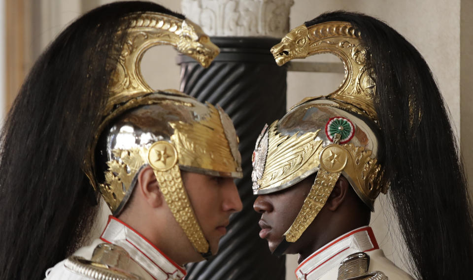 A moment of the changing of the guard at the door of Italian President Sergio Mattarella, in Rome, Thursday, Aug. 22, 2019. President Sergio Mattarella continued receiving political leaders Thursday, to explore if a solid majority with staying power exists in Parliament for a new government that could win the required confidence vote. (AP Photo/Alessandra Tarantino)