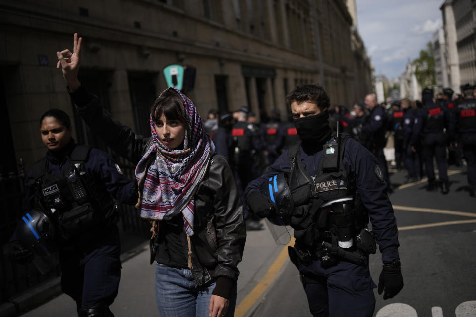 A student flashes the V sign during a demonstration outside La Sorbonne university, Monday, April 29, 2024 in Paris. About 100 Pro-Palestinian students demonstrate near the Sorbonne university in Paris. The demonstration came on the heels of protests last week at another Paris-region school, Sciences Po. (AP Photo/Christophe Ena)