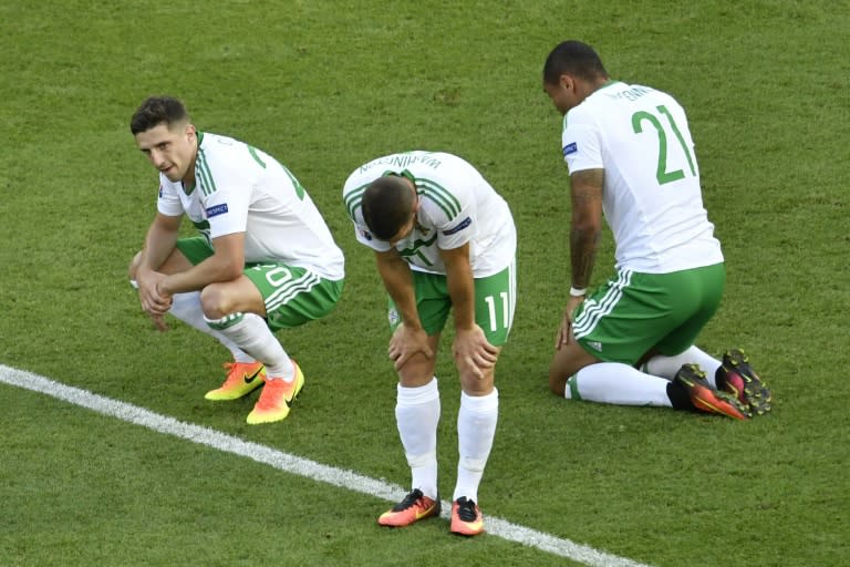 Northern Ireland's Josh Magennis (R), Conor Washington (C) and Craig Cathcart (L) after a 0-1 defeat in the Euro 2016 match Wales vs Northern Ireland, on June 25, 2016