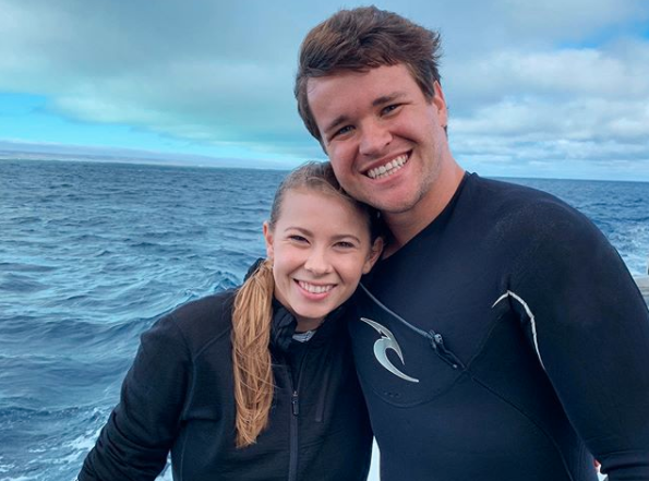 Bindi Irwin and Chandler Powell in wetsuits