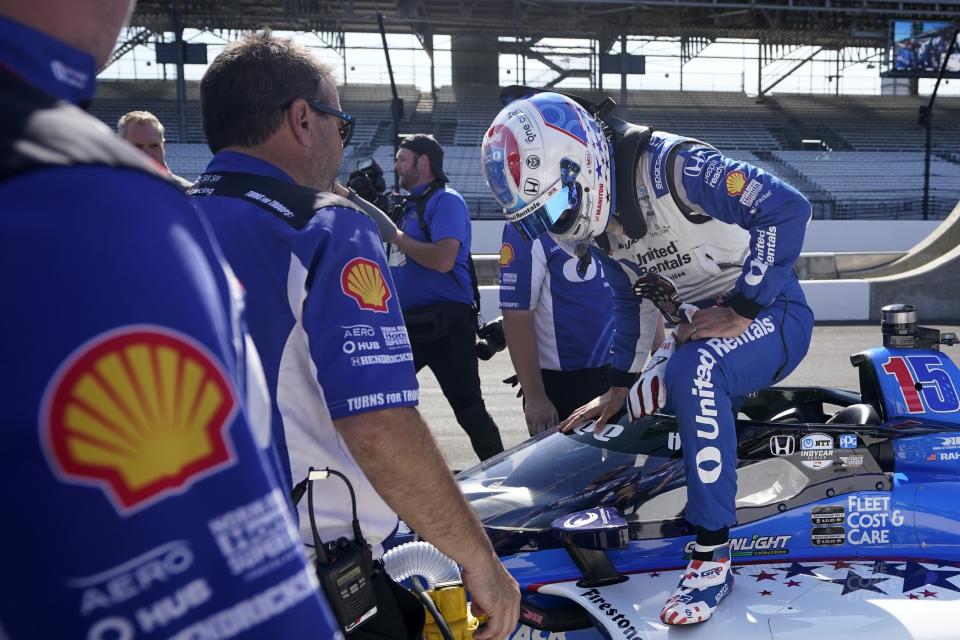 Graham Rahal climbs out of his car after getting bumped from the Indianapolis 500 auto race at Indianapolis Motor Speedway, Sunday, May 21, 2023, in Indianapolis. (AP Photo/Darron Cummings)