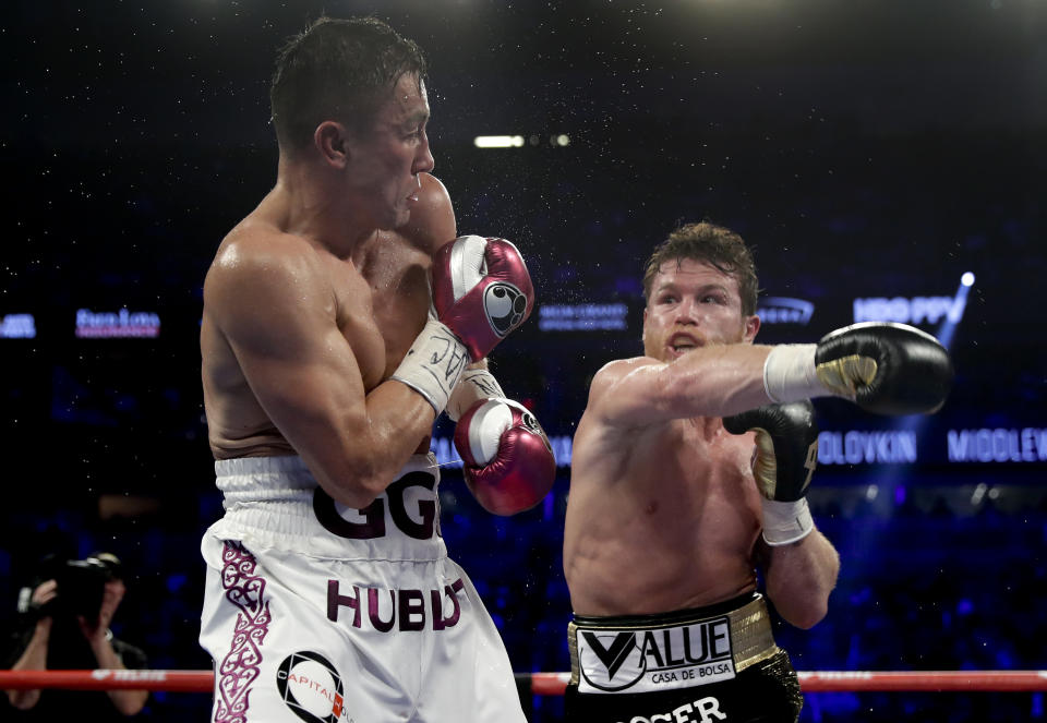 Gennady Golovkin, left, and Canelo Alvarez trade punches in the fifth round during a middleweight title boxing match, Saturday, Sept. 15, 2018, in Las Vegas. (AP Photo/Isaac Brekken)