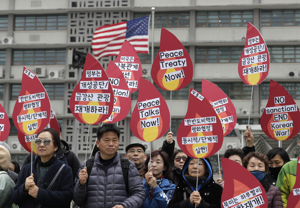 Protesters hold signs during a rally demanding the denuclearization of the Korean Peninsula and peace treaty near the U.S. embassy in Seoul, South Korea, Thursday, March 21, 2019. The Korean Peninsula remains in a technical state of war because the 1950-53 Korean War ended with an armistice, not a peace treaty. More than 20 protesters participated at a rally and also demanding the end the Korean War and to stop the sanction on North Korea. The letters read "Restarting operations at Kaesong industrial complex and Diamond Mountain resort." (AP Photo/Lee Jin-man)