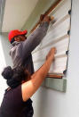 FILE PHOTO: A supplied image shows locals covering windows to office buildings as part of preparations for Cyclone Gita in the Tonga capital of Nuku'alofa, February 12, 2018. Taniela Hoponoa/CARE Australia/Handout via REUTERS